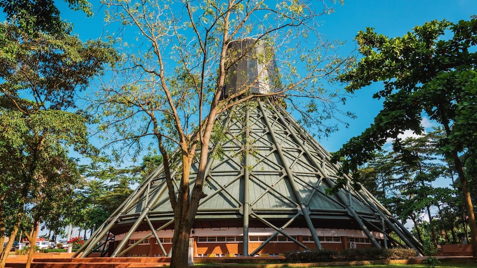 A pyramid-shaped building surrounded by trees.