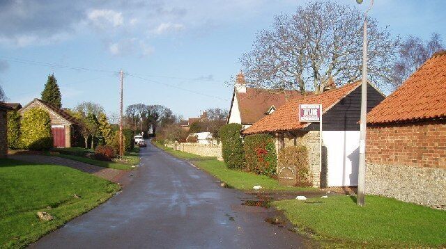 Radwell village. Looking down the northeasterly road in Radwell, with College Farm on the right