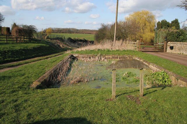 Village Pond, Glaston What looks to be a formal pool is actually a pond constructed about 1740. The wording on the sign (see 364733) says, "An ancient pond circa 1740 for soaking cart wheels to prevent ash wood shrinking from the iron tyres and also for horses hooves to prevent hardening" I hope the horses didn't get foot rot!
