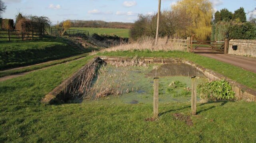 Village Pond, Glaston What looks to be a formal pool is actually a pond constructed about 1740. The wording on the sign (see 364733) says, "An ancient pond circa 1740 for soaking cart wheels to prevent ash wood shrinking from the iron tyres and also for horses hooves to prevent hardening" I hope the horses didn't get foot rot!