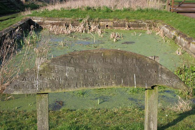 Village pond at Glaston The hand carved inscription on this wooden sign says: "An ancient pond circa 1740 for soaking cart wheels to prevent ash wood shrinking from the iron tyres and also for horses hooves to prevent hardening"