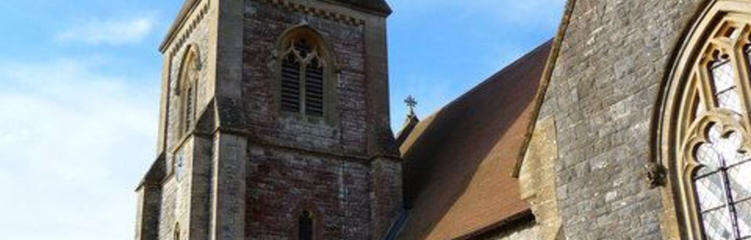 Uma igreja histórica com uma torre alta e janelas em arco.