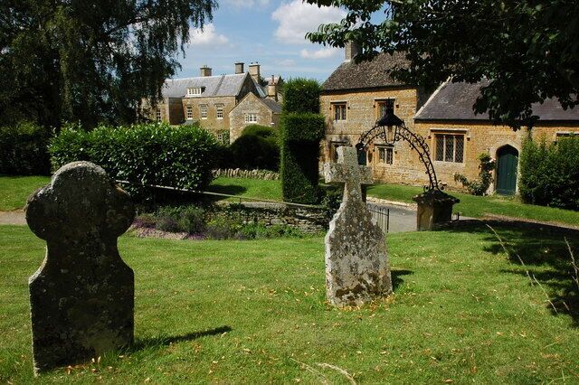Gravestones in Adlestrop churchyard In the background is Altestrop House which used to be the rectory.