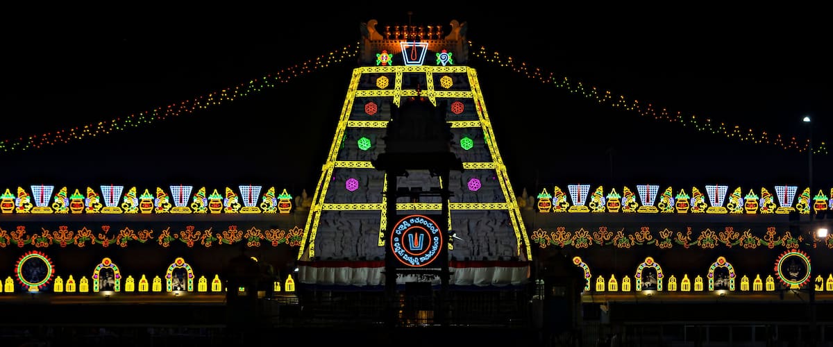 A brightly lit temple with intricate designs and a central statue.