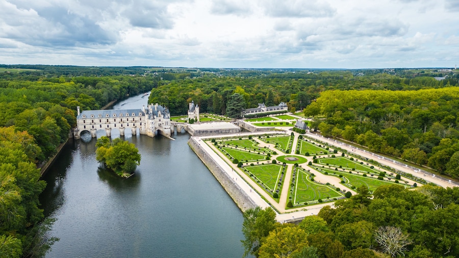 Aerial view of Château de Chenonceau, one of the most famous Loire Valley castles in France. Renaissance architecture spanning the River Cher, surrounded by lush forests and beautifully landscape