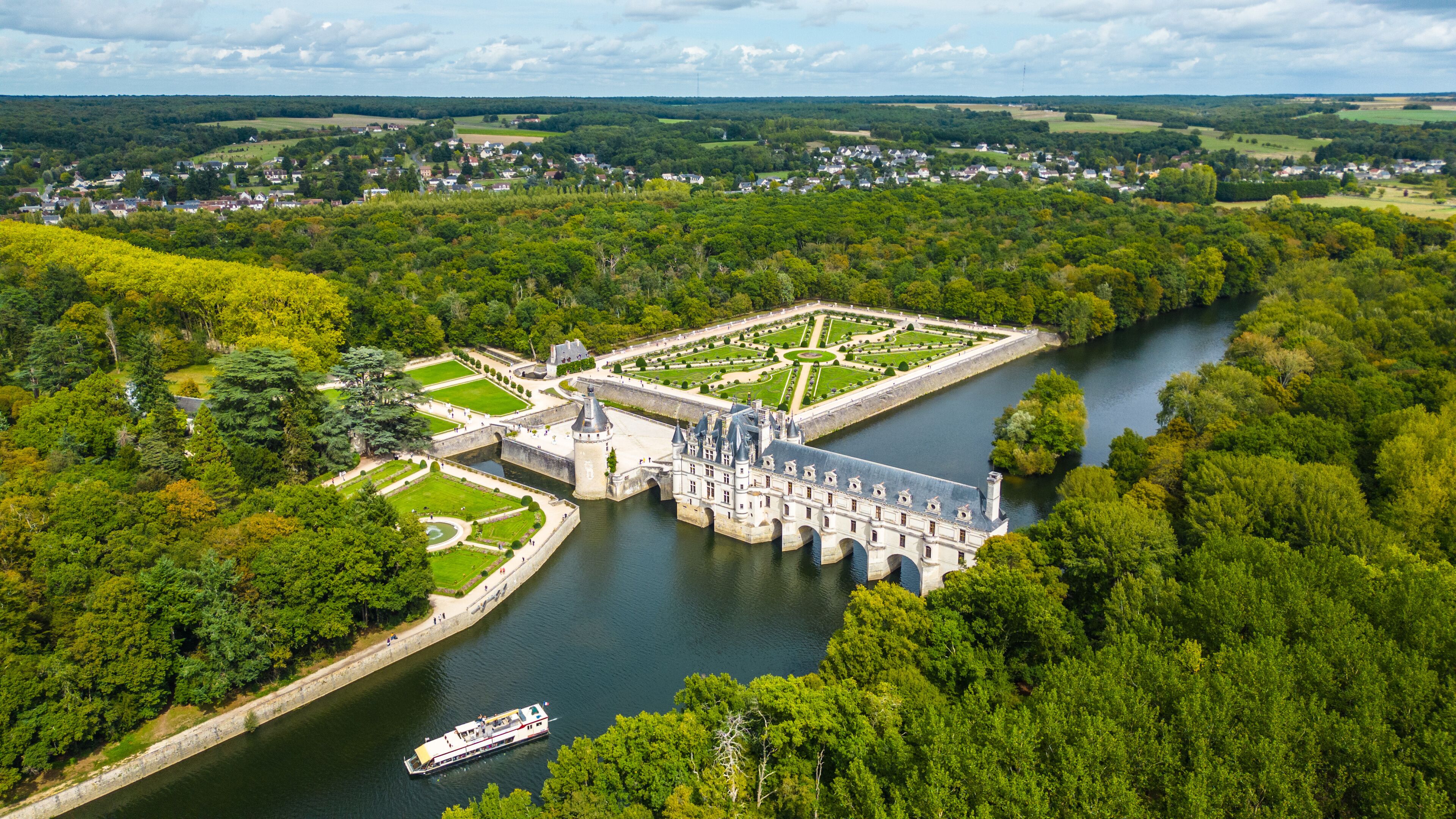Aerial view of Château de Chenonceau, one of the most famous Loire Valley castles in France. Renaissance architecture spanning the River Cher, surrounded by lush forests and beautifully landscape