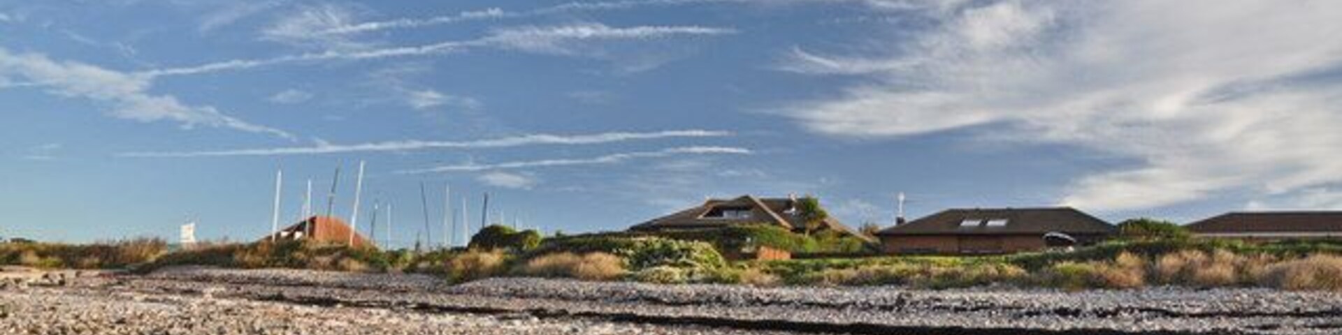 Sully Bay beach Perhaps 'beach' is stretching the description somewhat but ..... in a few million years - who knows? Sea front bungalows and the Sully Sailing Club can be seen on the skyline.