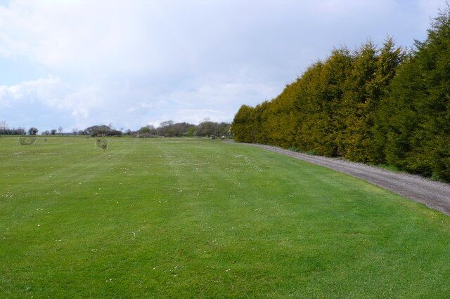 Folke Golf Club Driving Range The driving range is almost entirely in ST6614 while most of the rest of the club is in ST6613.This hedge forms the right hand (northern) boundary of the range. Only the extreme left (south) edge of the range is in ST6613. This is out of picture to the left. The NS grid line runs across the range just beyond the end of the hedge. The photographers position by GPS for this shot was ST6610614025 and everything in shot except the far distance is in ST6614