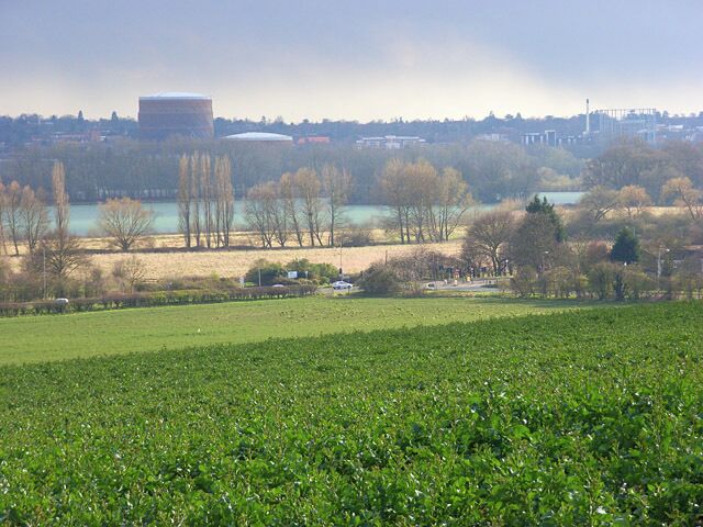 A view to the east of Caversham from Playhatch The view from Foxhill Lane. The crop is oil-seed rape. The first flowers are just starting to show. We are looking down on the Henley Road at its junction with Caversham Park Road with meadows and a former gravel pit on the floodplain beyond.