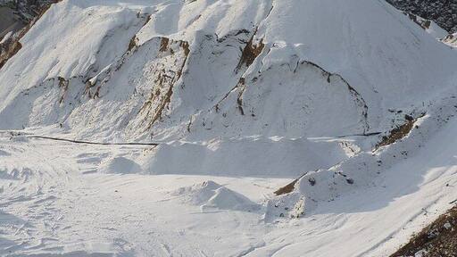 Snow capped peaks A gravel heap in Shiningbank Quarry, in winter