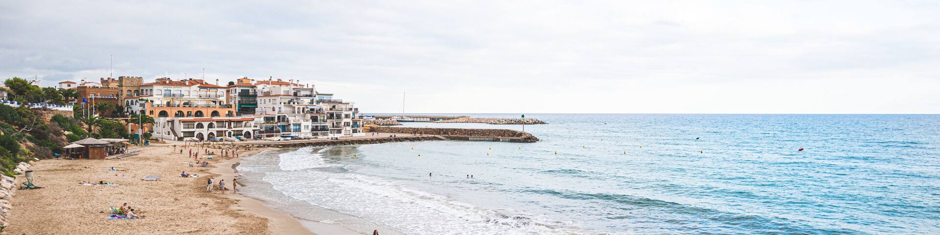 Beautiful white houses, mediterranean sea and a clear blue sky in the setting sun and sunset in El Roc de Sant Gaieta, Catalonia