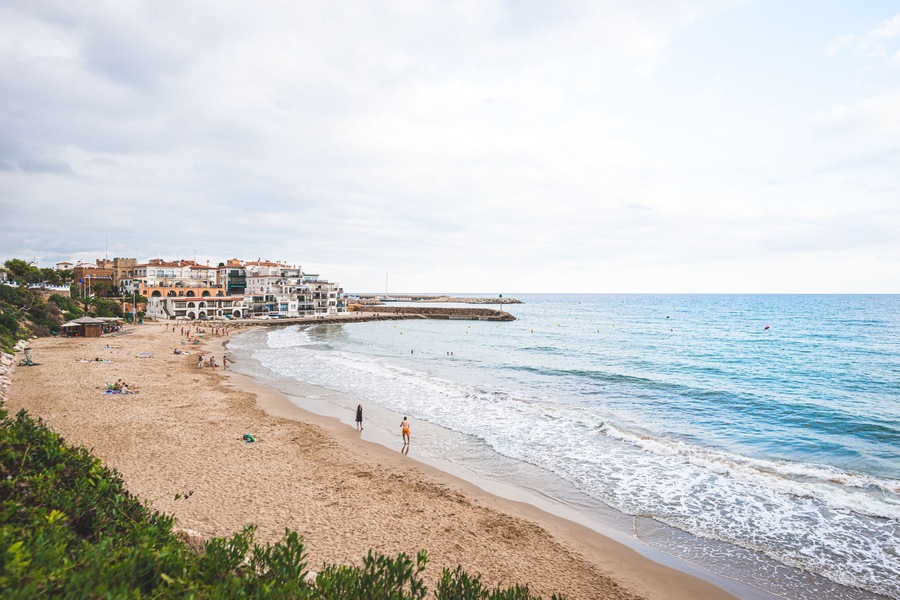 Beautiful white houses, mediterranean sea and a clear blue sky in the setting sun and sunset in El Roc de Sant Gaieta, Catalonia