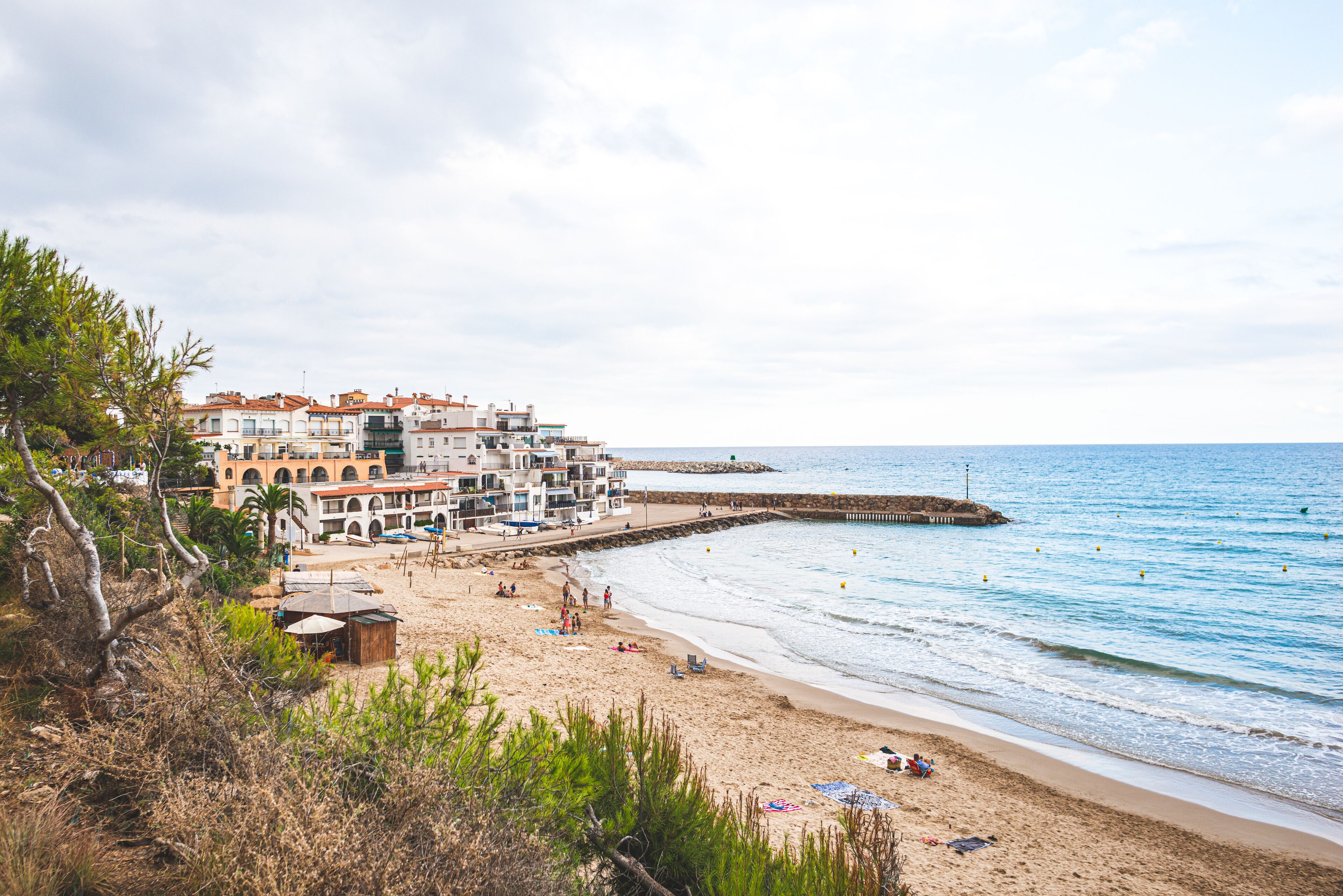 Beautiful white houses, mediterranean sea and a clear blue sky in the setting sun and sunset in El Roc de Sant Gaieta, Catalonia