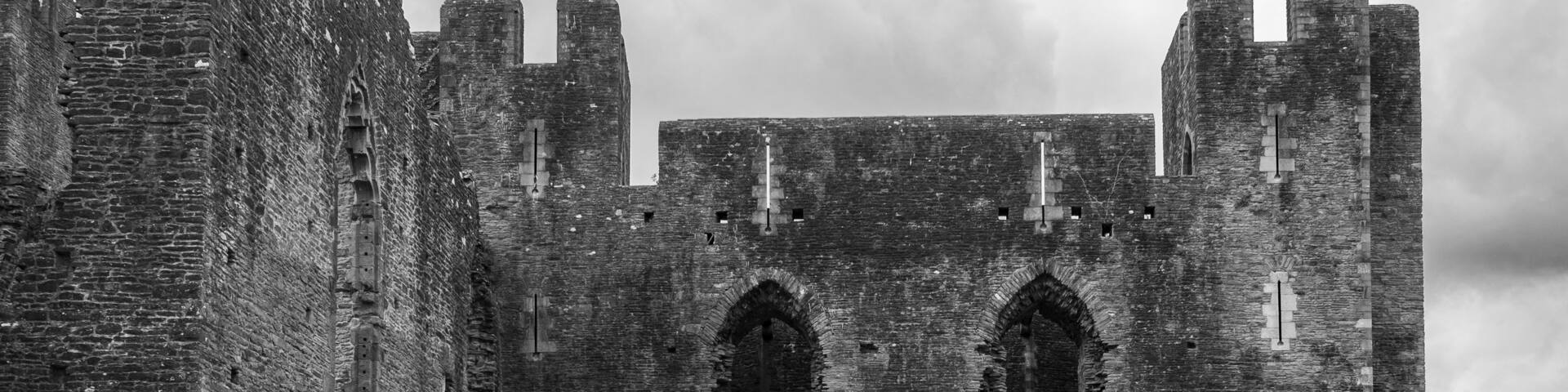 A historic castle with arched windows and battlements.