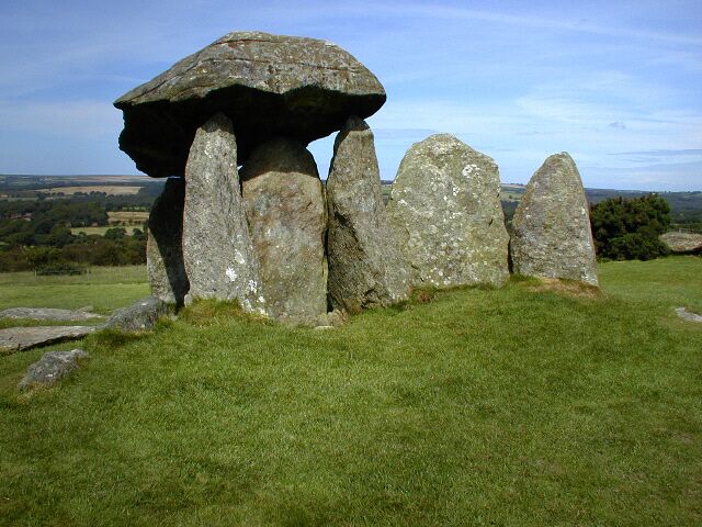 A stone circle with a large central stone and several upright stones.
