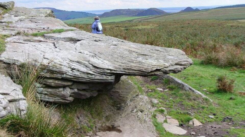Tor on Mynydd Eglwysilan. The exposed rocks just south of the summit show horizontal rock layers, jointing is opened by freeze-thaw action. Note the coal bings in the distance, and beyond these is England, across the Severn Estuary.