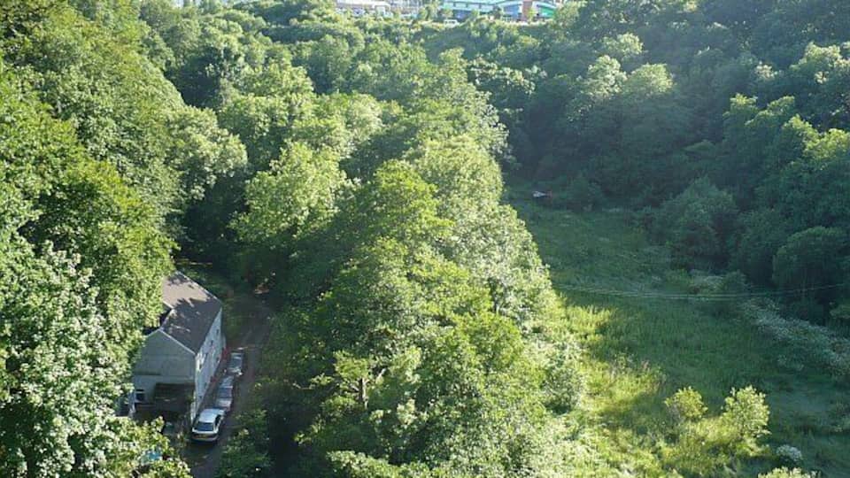 Sirhowy Valley. The view looking south from 601707. The roadway at the bottom left is part of the Sirhowy Valley Walk long distance footpath. The Sirhowy River is hidden in the trees to the right. Blackwood can be seen in the distance.