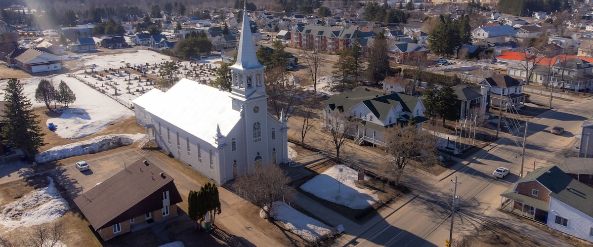 A town with a prominent church, residential houses, and a cemetery.