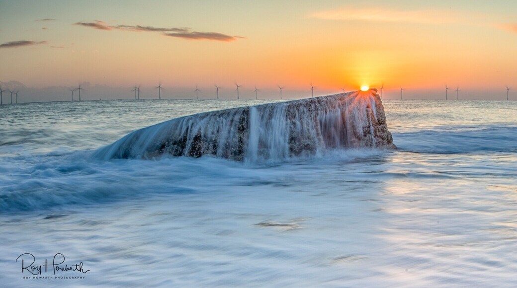 An old pill box at Caister on Sea Norfolk taken on a high tide at Sunrise