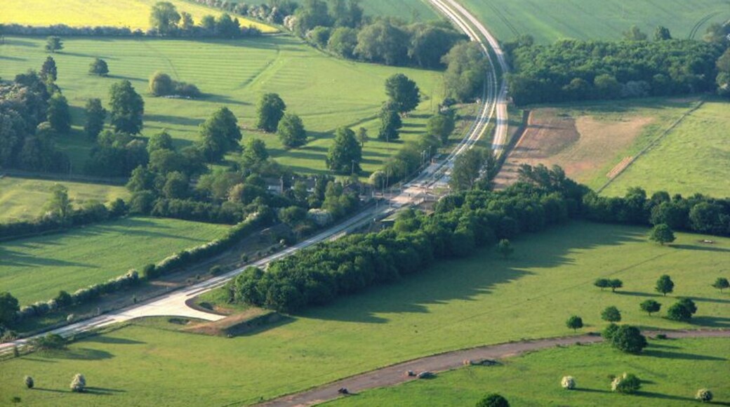 Guided busway at Oakington from a hot-air balloon, near to Westwick, Cambridgeshire, Great Britain. The concrete blocks of the hugely controversial, vastly over-budget and still-unopened Cambridge to St Ives guided busway snake across the fens, occupying the trackbed of the former railway. In the centre of the picture it is crossed by the Oakington-Cottenham road, where Oakington railway station once stood.
