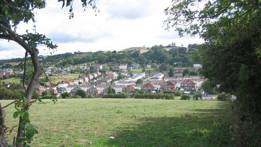 The Holway estate. A view looking south from a field entrance on the track to Moor Farm, showing the Holway estate and Pen-y-Ball hill behind.