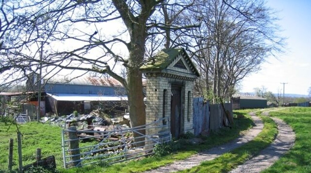 Ornamental Doorway by Old Hall Farm This impressive doorway, by Old Hall Farm on the bank of the River Dee, is not attached to anything else, and looks quite out of place. However, on the 1882 O.S. map there is a path leading from near here, and what was then called Dee Cottage, to a large landing stage on the River Dee. The 1881 census records Henry Hurlbutt, Timber Merchant, living at Dee Cottage, so it may have been his personal doorway for accessing his own landing stage.
