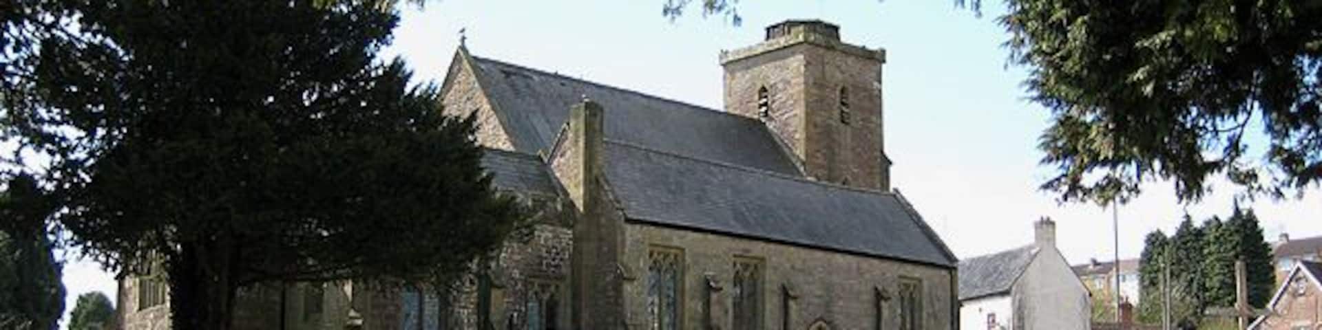 Church of St. Ethelbert, Littledean This once had a spire, but following a gale, it became unsafe and was removed in 1894. The clock on the tower is peculiar in that it bears no number 11. Roman numerals were used and IX appears twice instead of IX and XI. To the right of the picture, Littledean CE Primary School can just be seen.