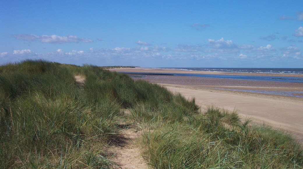 The coast near Burnham Overy Staithe, taken from the crest of the dunes at the end of the footpath from Staithe to beach. Beyond the dunes can be seen the entrance to the River Burn, which gives boat access to the Staithe. Beyond that is Scolt Head Island, a nature reserve accessible only by boat. For more information see the Wikipedia article Burnham Overy.