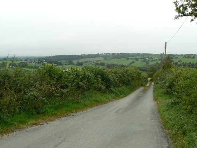 South of Ffinnant Isaf Minor road passing south of Ffinnant Isaf looking towards Llanwyddelan.
