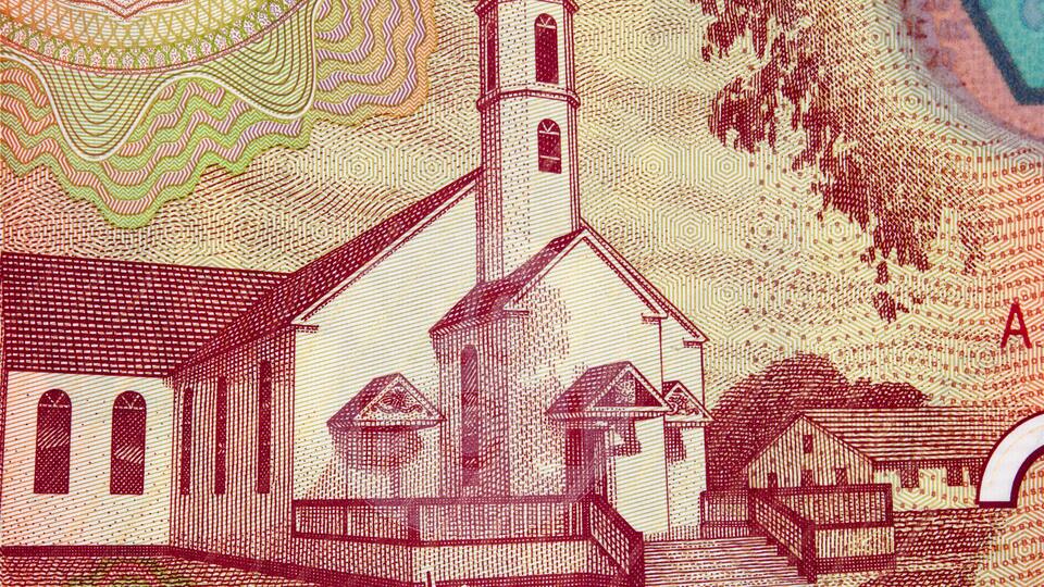 A church with a bell tower and a nearby building, surrounded by patterned designs.