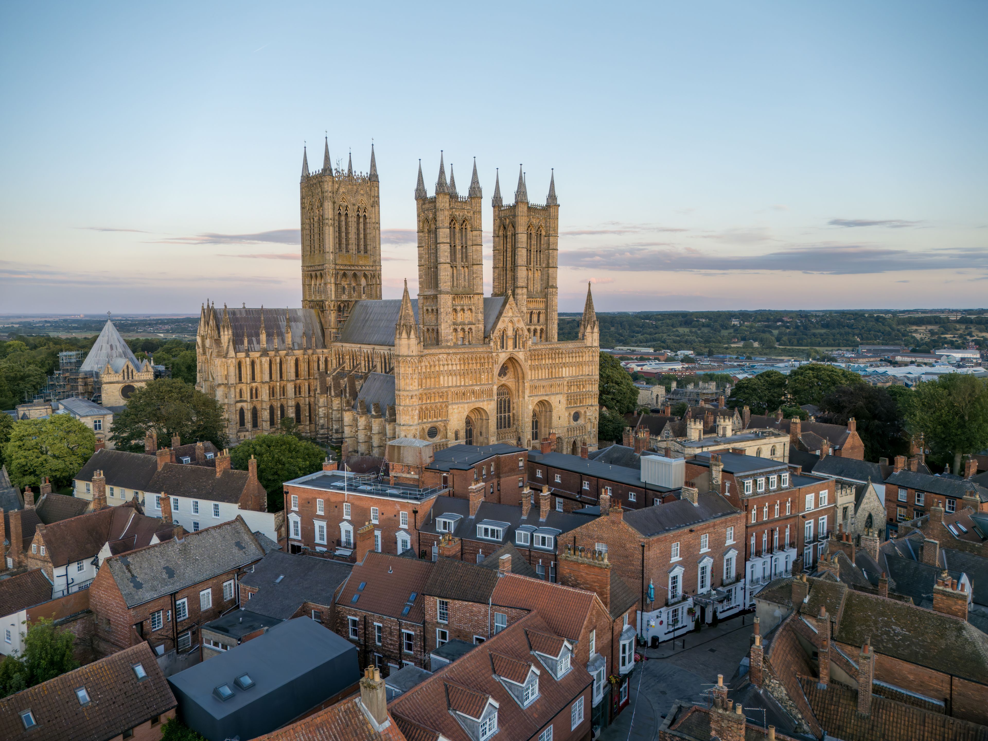 A historic cathedral with twin towers and a surrounding urban area.