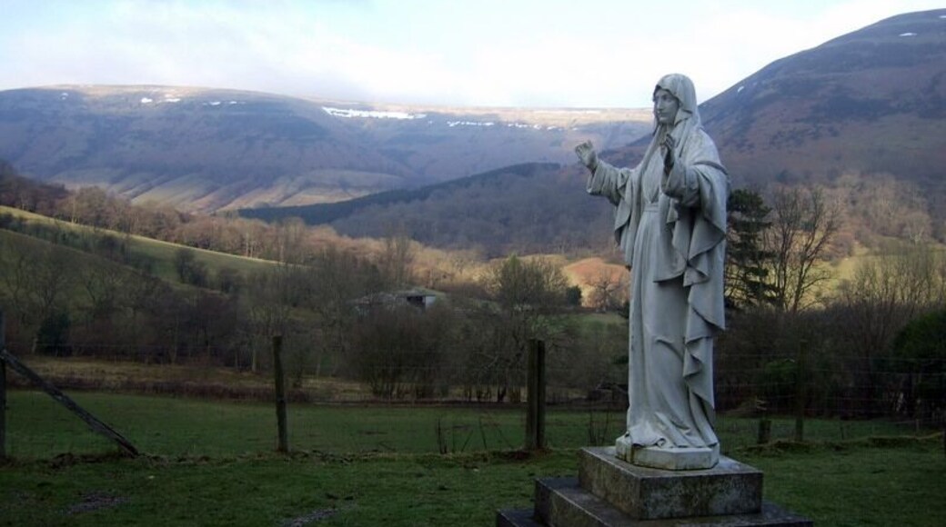 'Our Lady of Llanthony' The statue stands in front of the C19 monastery built by Father Ignatius and his monks and marks the vision of the Virgin Mary believed to have been seen by several of them near this spot in 1880. The view is across the Vale of Ewyas towards the most easterly ridge of the Black Mountains that marks the border between Wales and England.