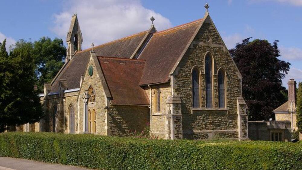 A historic stone church with a steep roof and arched windows.