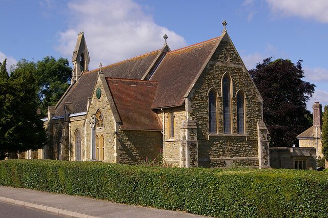 A historic stone church with a steep roof and arched windows.