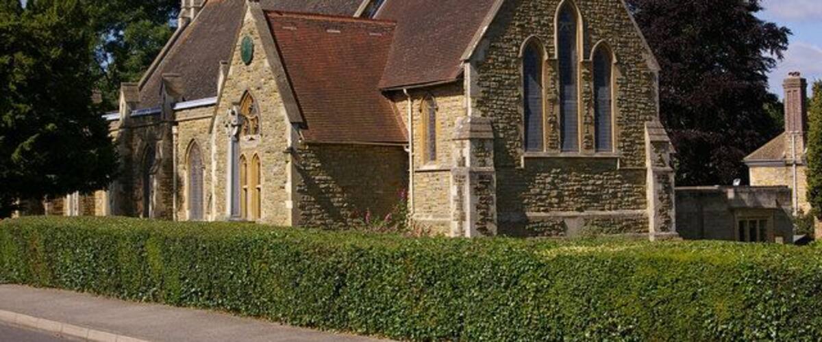 A historic stone church with a steep roof and arched windows.