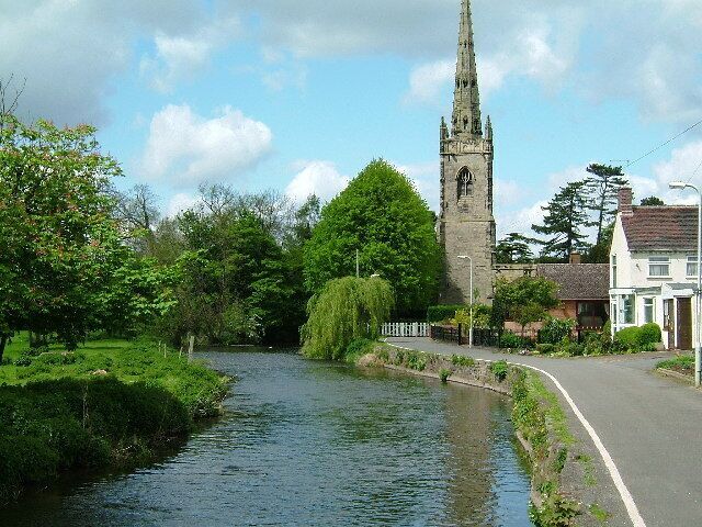 The River Anker at Witherley, Leicestershire, with the 15th-century tower and spire of St Peter's parish church in the background