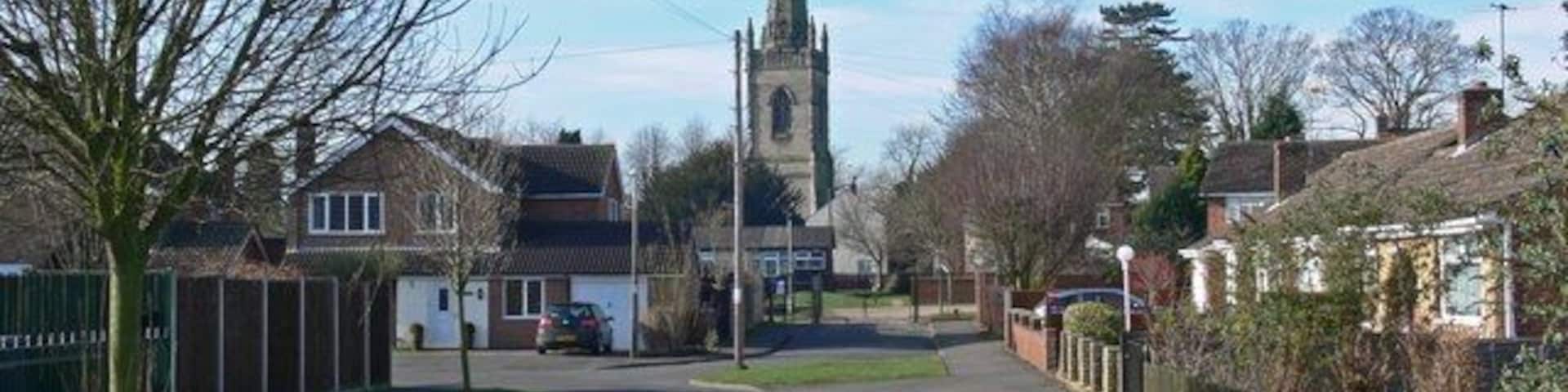 St Peters Avenue, Witherley, Leicestershire, with the 15th-century tower and spire of St Peter's parish church in the background