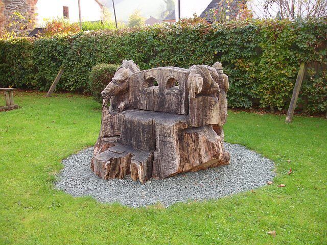 Carved seat, Pontrobert. A somewhat crudely carved seat (I think) in a picnic area in Pontrobert associated with the Ann Griffiths Walk. It depicts the bridge itself with a dragon, a knight and a bird. The date 2000 is carved on the other side. See also 591851.