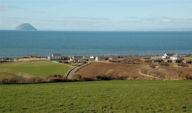 Lendalfoot View The village and Ailsa Craig, viewed from the minor road near Carleton Mains. The southern end of Arran is visible on the right, with the Kintyre peninsula in the background between Arran and the Craig.