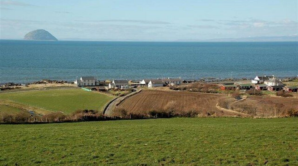 Lendalfoot View The village and Ailsa Craig, viewed from the minor road near Carleton Mains. The southern end of Arran is visible on the right, with the Kintyre peninsula in the background between Arran and the Craig.