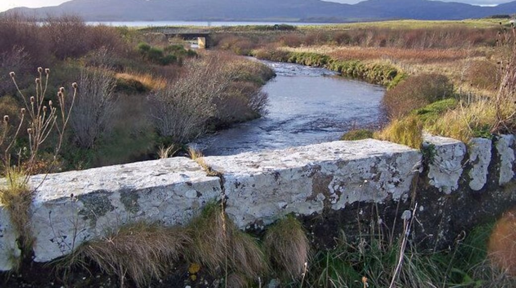 New bridge from the old The old and narrow stone bridge is now unused. The new bridge carries the A863 over the River Ose.