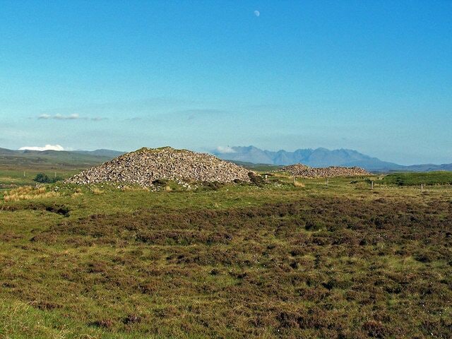 Barpannan chambered cairns To most passers by, these are just large piles of stones. However, they are Neolithic chambered cairns, and have been here for at least four thousand years. The Highland Environmental Record provides the following information: "A prominent, probably chambered cairn about 20' high and 90' in diameter, of relatively small, rounded boulders, partly turf-covered. There has been some robbing and disturbance, especially on the SW side near the top, but this appears to be quite superficial. The sides are steep, but the angle becomes more gentle near the edges giving the cairn a slightly bell-shaped profile. At the very edge of the cairn there is a kerb of stones, set either flat or on their long edges. The kerb-stones appear to have been contiguous originally, and remain so on the NE segment. Kerb-stones at short intervals can be traced round most of the east half and occasionally round the rest of the cairn. The stones seem to have varied considerably in size; the largest is 3' 2" high and about 6' long and others are 4' long, but some are relatively small. The profile of the cairn and the fact that the cairn material does not appear to have fallen outside the kerb suggests that the kerb originally edged a platform extending beyond the actual edge of the cairn. Another cairn showing some constructional similarities and probably chambered lies to the south (NG24SE 12). RCAHMS 1928; Information from MS of A S Henshall's 'Chambered Tombs of Scotland' Vol. 2, visited 24 October 1962." Highland Environmental Record website - http://her.highland.gov.uk/SingleResult.aspx?uid=MHG4849 .