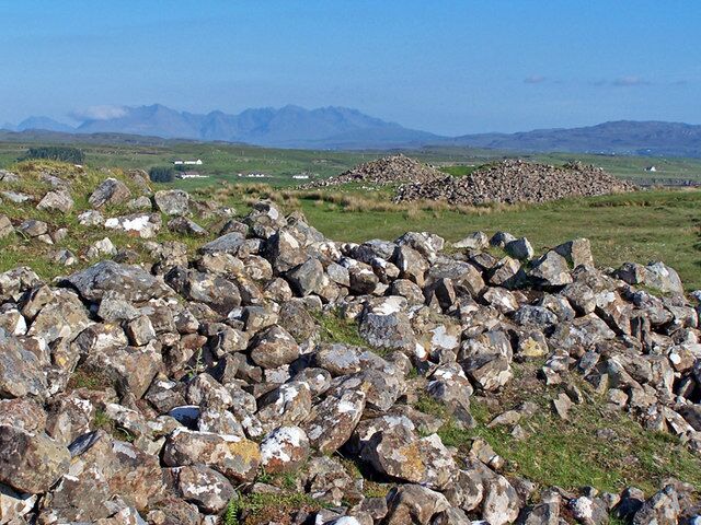 Barpannan chambered cairns (2). See full description here - 1335101 . The size of these neolithic cairns can only be fully appreciated when you get up close. There are no signposts or information at the site, so the majority of visitors to Skye drive past on the main road to Dunvegan without even noticing them. In this view, the Black Cuillin form the background.