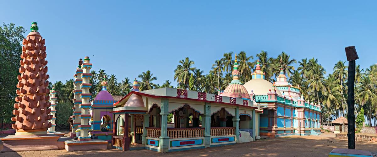 A colorful temple with multiple domes and a large spire.