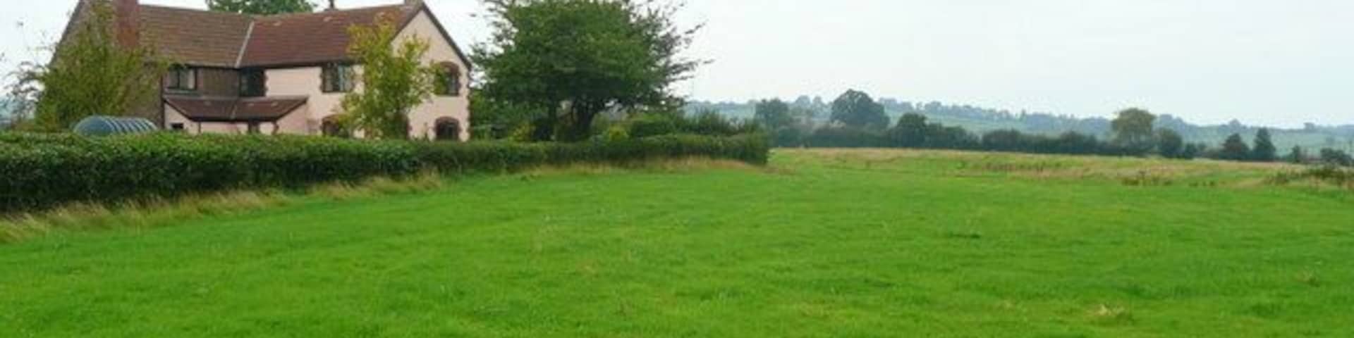 House and pasture at Tre Essey Cross Looking south-west with Llancloudy Hill in the distance.