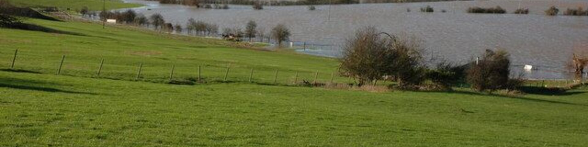Flooded Avon north of Tewkesbury View down the flooded Avon valley towards Tewkesbury, the high ground on the opposite side is the Mythe Hill. On the horizon to the left is May Hill with its distinctive clump of trees on the summit.