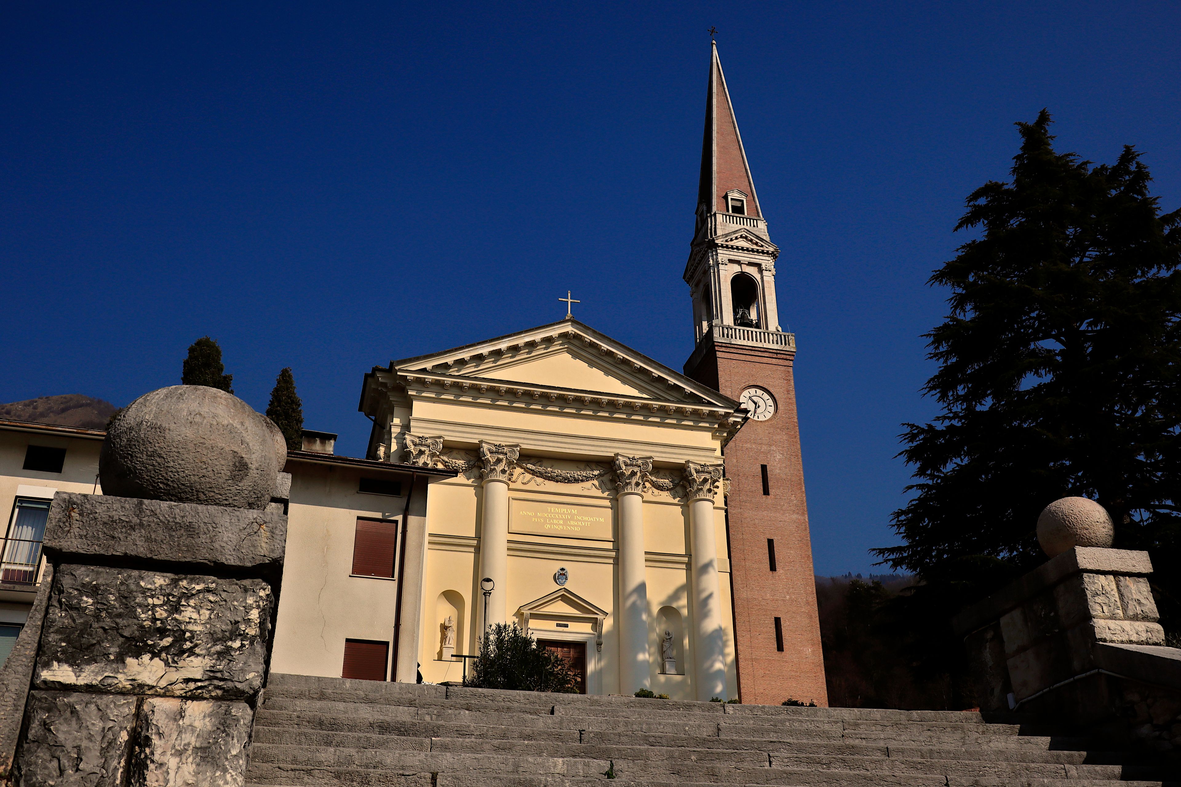 A church with a tall bell tower and a clock.