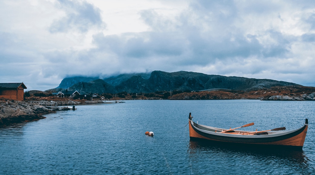 Dønna Mountain in Northern Norway is seen from the sea level with a row boat in the foreground.