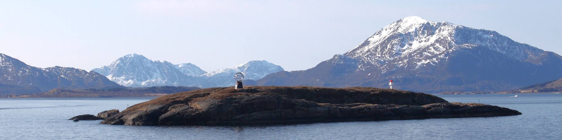 Rodoy, Helgeland, Nordland, Norway, April 2019. Norwegian island Vikingen with globe statue marking polar circle. Arctic Circle is an imaginary line of latitude that circles Earth's northernmost poin