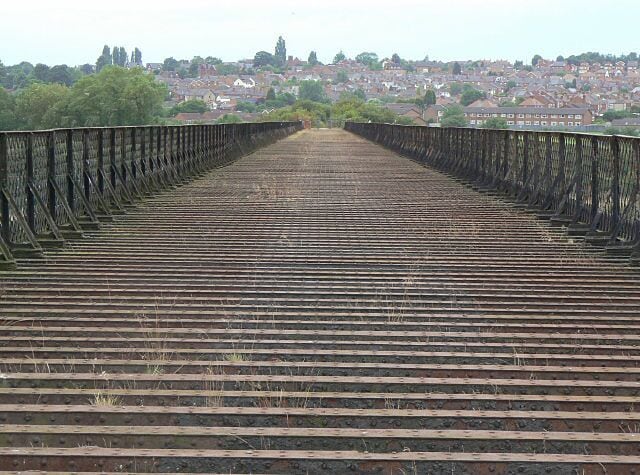 On Bennerley Viaduct This fine wrought iron structure is a listed monument. A proposed foot- and cycleway across the Viaduct has not come to fruition, although it is possible to walk across. In the distance is Cotmanhay, a suburb of Ilkeston.